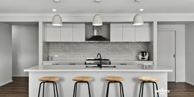 This contemporary kitchen features a spacious island and modern appliances, perfect for culinary enthusiasts.
