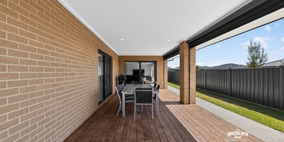 Spacious outdoor patio area perfect for entertaining, featuring a modern design and low-maintenance landscaping.