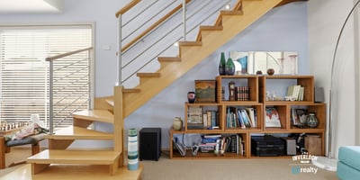 Bright, open space featuring a modern staircase and custom shelving, ideal for showcasing your belongings.
