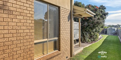 Spacious outdoor area with well-maintained landscaping and ample natural light streaming through large windows.