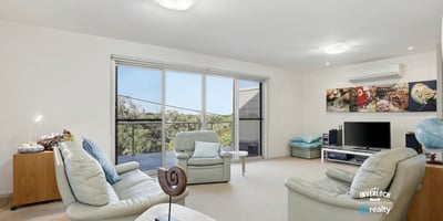 Bright and inviting living space featuring large windows and a seamless connection to the outdoor views.