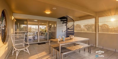 Spacious outdoor terrace featuring a spiral staircase, perfect for relaxation and entertaining with scenic views.