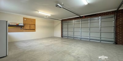 Spacious garage featuring ample storage options and abundant natural light, ideal for vehicles and projects.