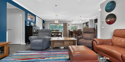 Spacious living area featuring vibrant decor, comfortable seating, and an inviting atmosphere for gatherings.