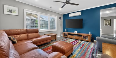 Spacious living area featuring modern furnishings, vibrant colors, and ample natural light for comfortable gatherings.