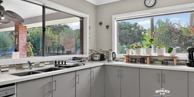 Modern kitchen featuring spacious countertops and abundant natural light, ideal for culinary enthusiasts and gatherings.