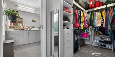 Spacious walk-in closet seamlessly connects to the laundry area, offering practical organization and efficient living.