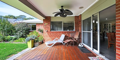 Spacious outdoor deck area perfect for relaxing or entertaining, surrounded by lush greenery and inviting atmosphere.