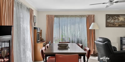 Bright and inviting living space featuring large windows, a dining area, and comfortable seating for relaxation.