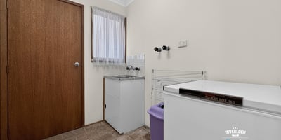 Functional laundry space featuring ample storage and convenient layout for efficient household management.
