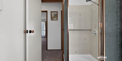 This bathroom features a convenient layout with practical finishes just steps from the living area.