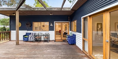 Spacious deck perfect for outdoor entertaining, seamlessly blends indoor and outdoor living in a picturesque setting.