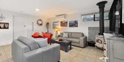 Bright and inviting living space featuring modern furnishings and a cozy fireplace, perfect for relaxation.