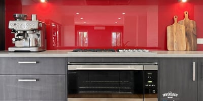 Modern kitchen featuring sleek cabinetry, a vibrant backsplash, and high-end appliances for culinary enthusiasts.