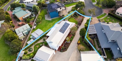 Spacious property featuring a large outdoor area and solar panels, nestled in a modern neighborhood.