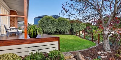 Inviting outdoor space with landscaped garden and seating area, perfect for relaxation and entertaining.