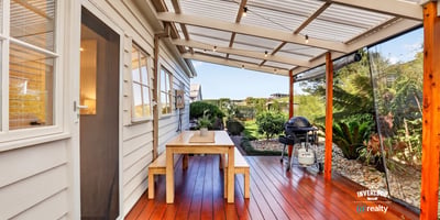 Enjoy outdoor living on this spacious deck, surrounded by lush greenery and perfect for entertaining.