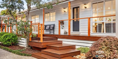 Experience modern living in this inviting home featuring a spacious deck, lush landscaping, and abundant natural light.