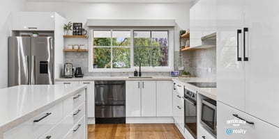 Modern kitchen featuring sleek cabinetry, stainless steel appliances, and abundant natural light for an inviting atmosphere.