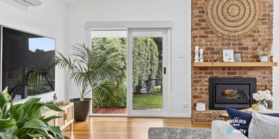 Bright living space featuring a cozy fireplace, modern amenities, and seamless indoor-outdoor access.