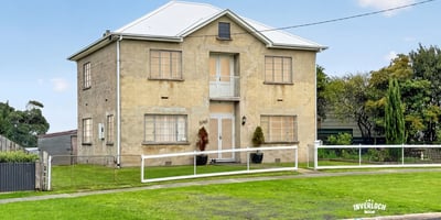 Spacious two-story home featuring ample yard space and unique architectural details in a quiet neighborhood.