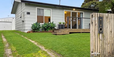This cozy home features a spacious yard, modern design elements, and convenient access to local amenities.