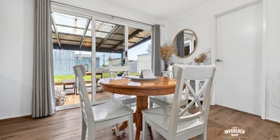 Bright dining area with outdoor access, perfect for enjoying meals and entertaining in a spacious layout.