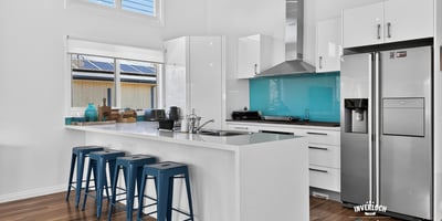 Modern kitchen featuring sleek cabinetry, vibrant backsplash, and functional layout ideal for entertaining.