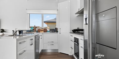Bright and modern kitchen featuring sleek cabinetry and ample counter space, perfect for culinary enthusiasts.