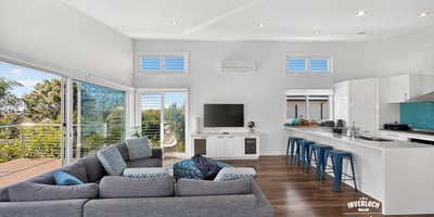 Bright, open-concept living space featuring modern design, large windows, and a seamless flow to outdoor views.