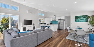 Modern open-plan living space with abundant natural light, featuring a spacious kitchen and inviting entertainment area.