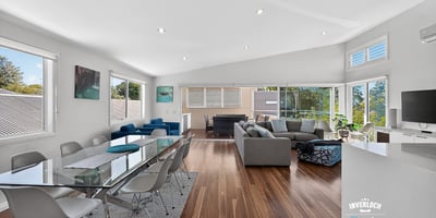 Spacious open-plan living area with abundant natural light, modern furnishings, and picturesque views.