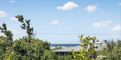 Enjoy stunning coastline views from this elevated property, surrounded by lush greenery and peaceful ambiance.