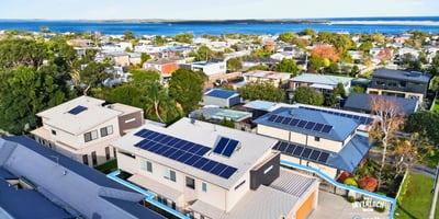 Modern home featuring solar panels and picturesque views, nestled in a vibrant coastal community.