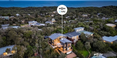 This coastal home offers breathtaking ocean views and modern architecture, nestled among lush greenery.