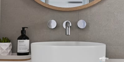 Sleek modern sink with a circular design, complemented by contemporary fixtures and minimalist decor.