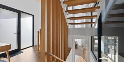 Contemporary open staircase showcases modern design, enhancing the home's inviting and spacious atmosphere.