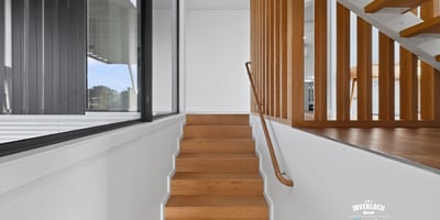 Modern staircase featuring sleek lines and natural light, seamlessly connecting spaces in a contemporary home.