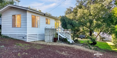 This inviting home features ample natural light, a spacious yard, and a peaceful setting near nature.