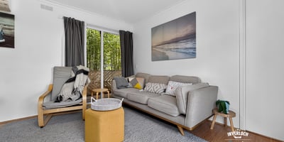 Bright and inviting living space featuring large windows, modern furnishings, and a seamless connection to outdoor views.