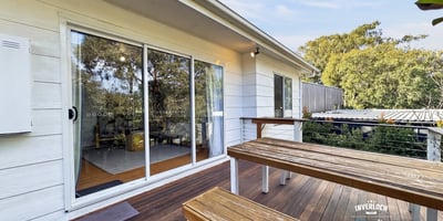 Bright outdoor space featuring a spacious deck, perfect for gatherings and enjoying the surrounding greenery.