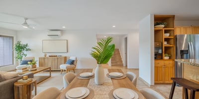 Bright, open-plan living area featuring modern furnishings and a seamless flow into the kitchen and dining spaces.