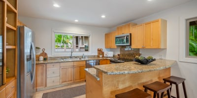 Modern kitchen featuring granite countertops, ample storage, and an open layout, perfect for entertaining.