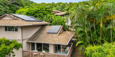 Discover this unique home surrounded by lush greenery, featuring solar panels and ample outdoor space.