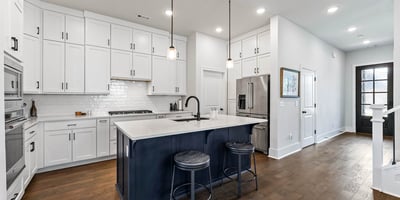 Kitchen with island and cabinets to the ceiling for extra storage