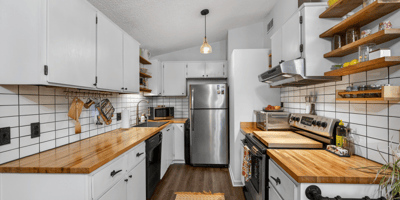 Modern kitchen featuring sleek cabinetry, butcher block countertops, and ample storage for all your culinary needs.