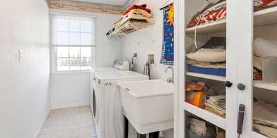 A convenient 2nd Floor Laundry Room with washtub sink and room for a storage cabinet and shelving.