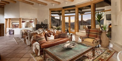 Enjoy unobstructed views of Camelback Mountain and the Valley from this airy, southwest-style great room. Soaring ceilings with wooden beams and a cozy seating area make it a welcoming space for both quiet evenings and entertaining.