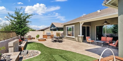 The covered patio and landscaped yard create an inviting outdoor extension of the home, perfect for entertaining, dining, or quiet evenings in Phoenix.