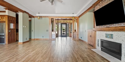 A custom fireplace, built-in cabinetry, and architectural wood accents anchor this living space, offering both style and comfort in a well-appointed Phoenix home.